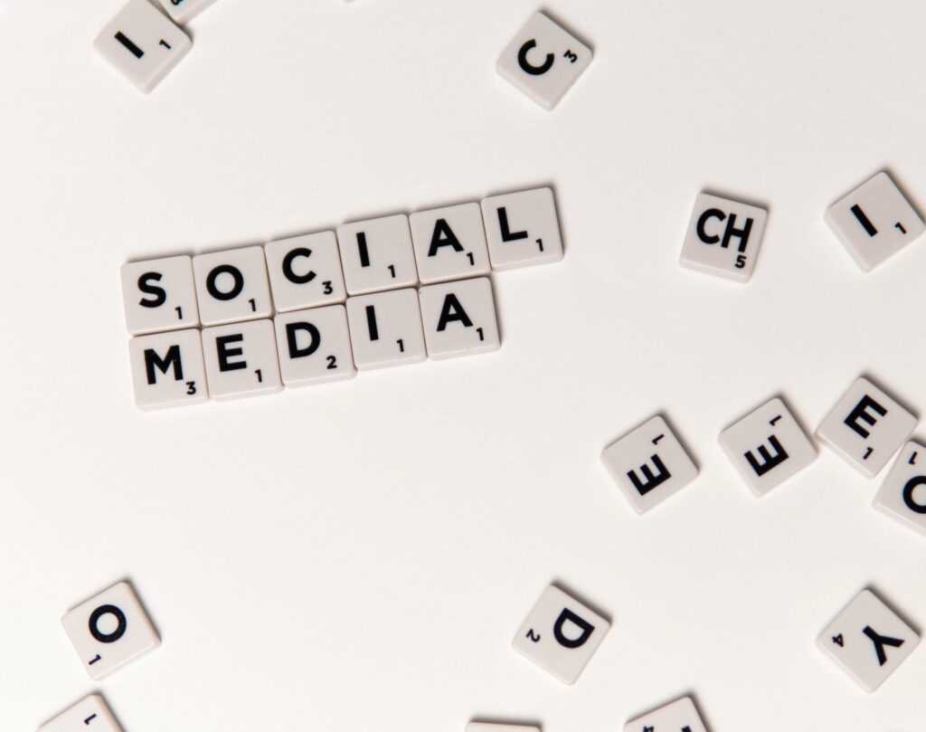 Scrabble tiles spelling 'Social Media' on a white background, symbolizing digital communication.